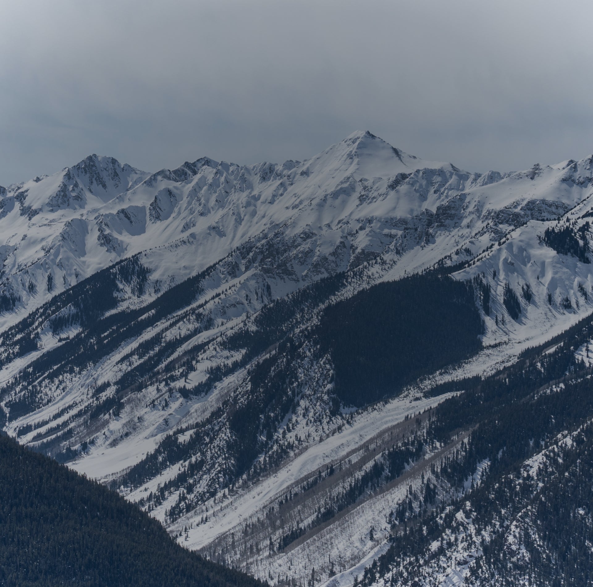 Snow-covered mountain range with a clear sky
